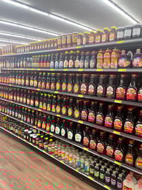 In-store gondola shelving display with multiple adjustable shelves, designed for organized and effective product merchandising.