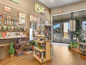 Store showing different angle of slatwall and wire grid displays with avian art